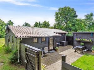 a small house with a fence and a patio at Holiday Home Bedine - 1-3km from the sea by Interhome in Gilleleje