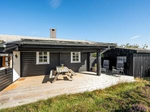 a wooden deck in front of a house at Holiday Home Christl - 500m from the sea by Interhome in Henne Strand