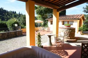 a patio with a table and chairs and a house at House near Milano in Cologno Monzese