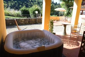 a bath tub filled with water on a patio at House near Milano in Cologno Monzese +6 photos