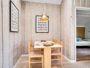 a dining room with a table and two chairs at Holiday Home Hedde - 100m from the sea by Interhome in Askeby