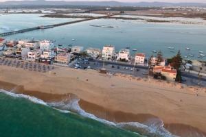 an aerial view of a beach and the ocean at Beach House on Faro Island with a Dreamy Terrace and 7 Beds for the Perfect Escape in Faro