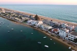 an aerial view of a beach with houses and boats at Beach House on Faro Island with a Dreamy Terrace and 7 Beds for the Perfect Escape in Faro +22 photos