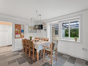 a dining room with a table and chairs at Holiday Home Slavomira - 12km from the sea by Interhome in Bredebro