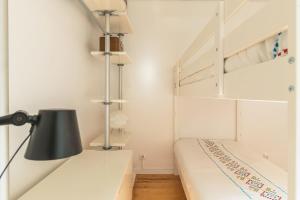 a white room with a bed and a lamp at Casa Veraneio by LovelyStay in Santo Tirso +62 photos