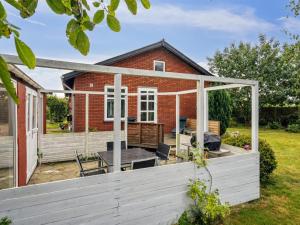 an extension to a brick house with a patio at Holiday Home Saja - 550m from the sea by Interhome in Børkop +19 photos
