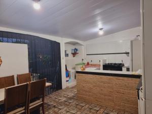 a kitchen with a table and a counter top at Casa família COP30 in Belém