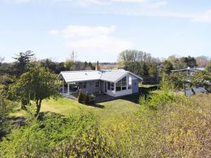 a house in the middle of a field at Holiday Home Frido - 500m from the sea by Interhome in Sæby