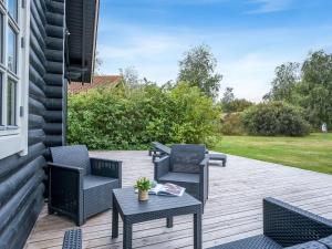 a patio with two chairs and a table at Holiday Home Salmina - 900m from the sea by Interhome in Marielyst