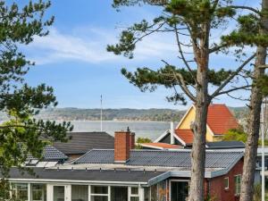 a house with solar panels on the roof at Holiday Home Elmeri - 200m from the sea by Interhome in Ebeltoft