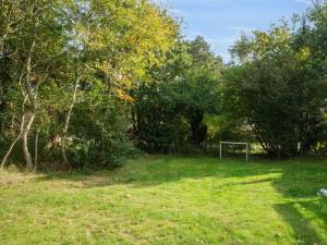 a field with a soccer goal in the grass at Holiday Home Elmeri - 200m from the sea by Interhome in Ebeltoft