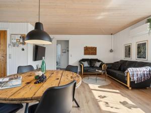 a living room with a table and a couch at Holiday Home Vemund - 500m from the sea by Interhome in Aabenraa +10 photos
