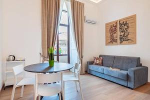 a living room with a table and a couch at Dimore Donna Serafina in Catania