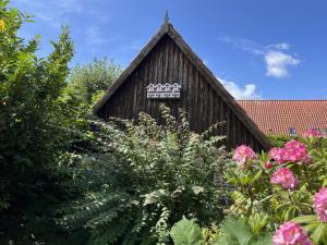 a wooden building with a sign on it at Holiday Home Skyler - 250m from the sea by Interhome in Gudhjem