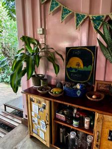 a table with a potted plant on top of it at Jinja Jungle Glamping Tent 2025 in Jinja