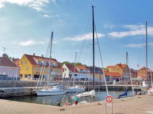 a group of boats docked in a marina with buildings at Apartment Franca - 75m from the sea by Interhome in Allinge