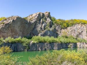 a mountain with green water and trees at Apartment Franca - 75m from the sea by Interhome in Allinge