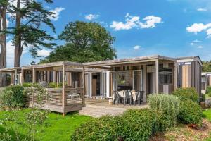 a modular home with a deck and patio at Camping maeva Respire Le Village Perrosien in Perros-Guirec