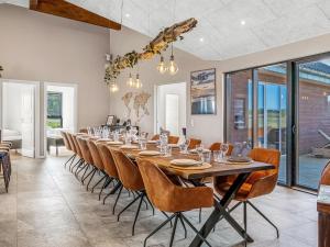 a long dining room with a long table and chairs at Holiday Home Sönke - 4km from the sea by Interhome in Tagholm