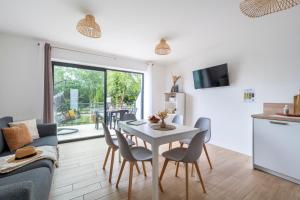 a kitchen and living room with a table and chairs at Camping maeva Respire Le Village Perrosien in Perros-Guirec