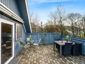 a patio with a table and chairs next to a house at Holiday Home Ely - 980m to the fjord by Interhome in Hemmet