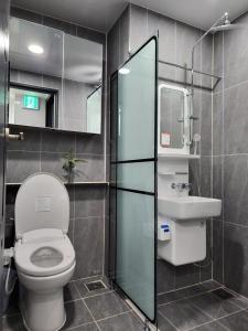 a bathroom with a toilet and a sink at 광안리 T-OCEAN House in Kwangan-dong +17 photos