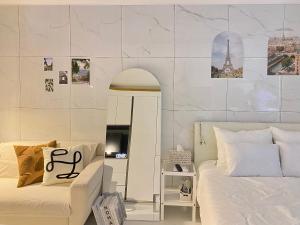 a bedroom with two beds and a wall with monuments at 광안리 T-OCEAN House in Kwangan-dong