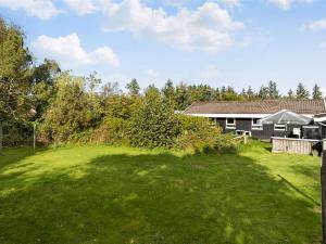 a large yard in front of a house at Holiday Home Gonda - 2km from the sea by Interhome in Saltum +18 photos