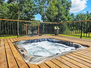 a hot tub sitting on top of a wooden deck at Chalet Tomina Koliba Lika by Interhome in Lovinac