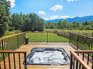 a hot tub on a wooden deck with a view at Chalet Tomina Koliba Lika by Interhome in Lovinac
