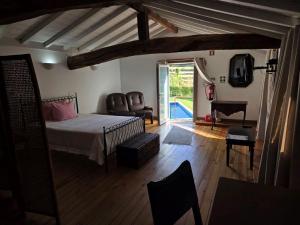 a bedroom with a bed and a room with a piano at Casa dos Bernardos in Terras de Bouro +55 photos