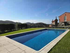 a swimming pool in the yard of a house at Casa dos Bernardos in Terras de Bouro
