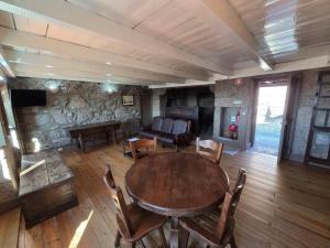 a living room with a table and chairs and a couch at Casa dos Bernardos in Terras de Bouro
