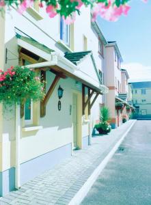 a street in a town with buildings and flowers at Tralee Town Centre Apartments in Tralee