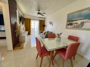 a dining room and living room with a table and chairs at Bayahibe Apartment by the Beach in Bayahibe
