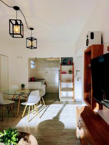 a living room with a table and a dining room at Sunset Loft in Pinamar