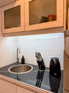 a kitchen counter top with a sink and a counter top at Sunset Loft in Pinamar