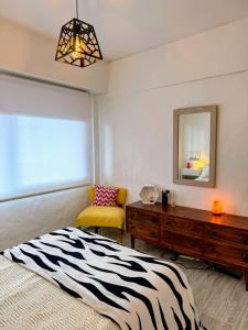 a bedroom with a zebra print bed and a dresser at Sunset Loft in Pinamar