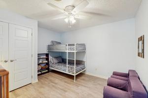 a living room with a couch and a ceiling fan at Bluebonnet Cove in Kingsland