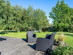 three wicker chairs sitting on a wooden deck at Holiday Home Bengta - 500m from the sea by Interhome in Gedser