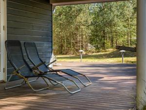 a metal chair sitting on a porch at Holiday Home Eikka - 1km from the sea by Interhome in Læsø
