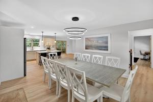 a dining room and kitchen with a table and chairs at Gray Woodland Escape Golf, Pool & Cinema home in Gray