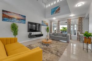 a living room with a couch and a tv at Nevas Estate w Hot Tub 10 ppl in St Mary