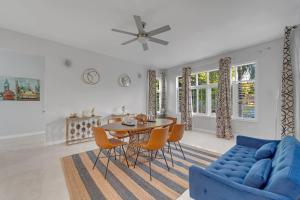 a living room with a blue couch and a table and chairs at Nevas Estate w Hot Tub 10 ppl in St Mary