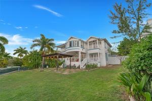 a large white house with a large yard at Nevas Estate w Hot Tub 10 ppl in St Mary