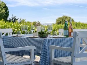a blue and white table with glasses and wine bottles at Holiday Home Devis - 75m from the sea by Interhome in Assens