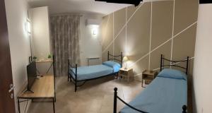 two twin beds in a room with a mirror at Dolce Dimora in Milazzo +2 photos