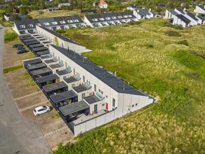 an aerial view of a building on a grassy hill at Holiday Home Mimi - 900m from the sea by Interhome in Blokhus