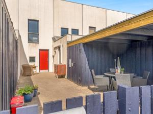a patio with a table and chairs next to a building at Holiday Home Mimi - 900m from the sea by Interhome in Blokhus