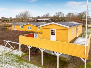 a modular home with a large yellow house at Holiday Home Ung - 650m to the fjord by Interhome in Struer +17 photos